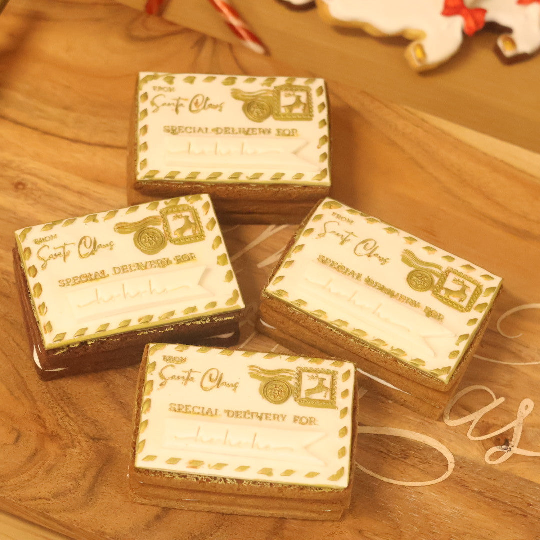 Four small boxes with decorative labels on a wooden surface