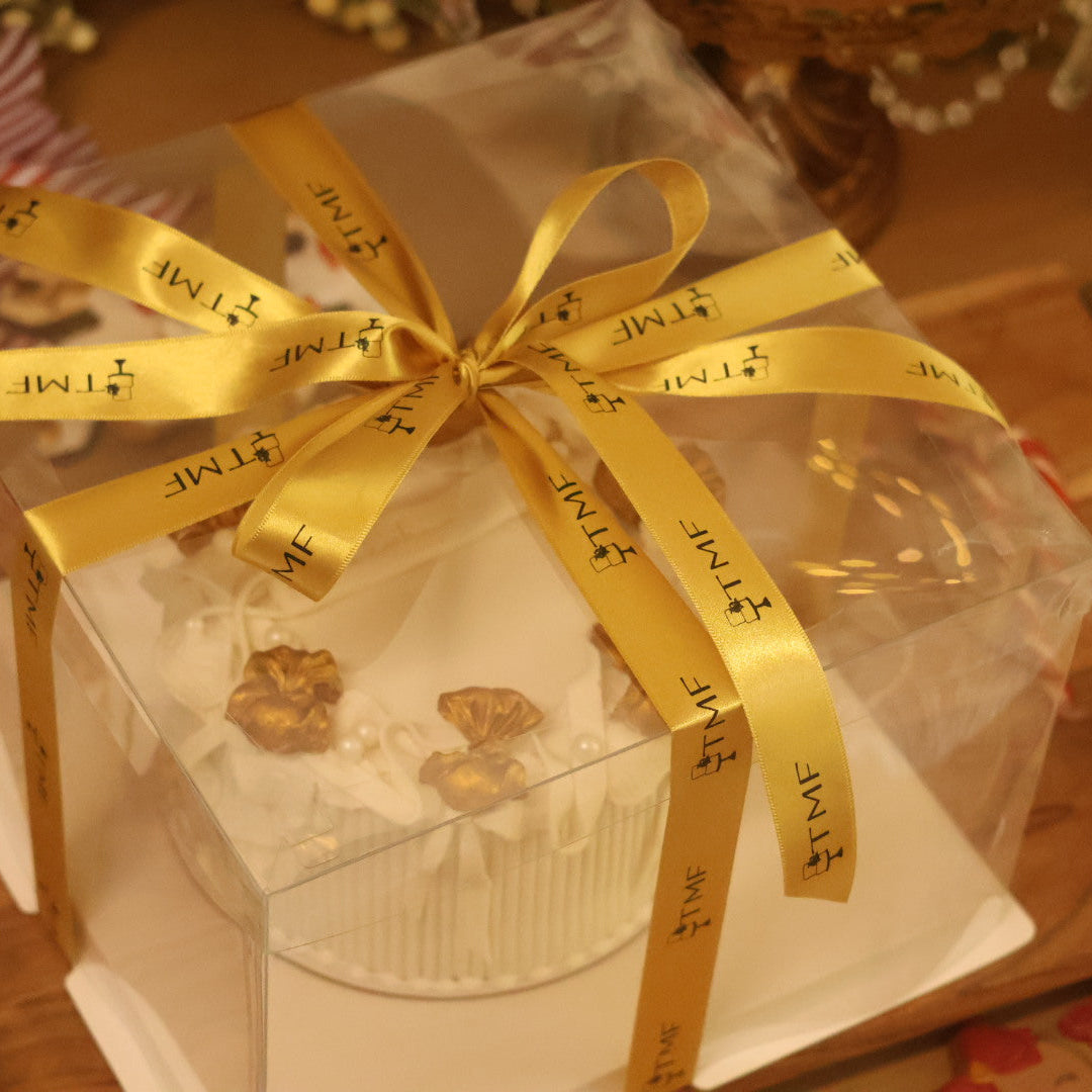 Gift box with a gold ribbon on a festive background