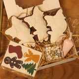 Decorative Christmas cookies in a box on a wooden surface with 'Merry Christmas' text.