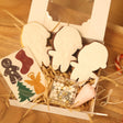 Decorative items including gingerbread men, candy canes, and a box on a wooden floor.